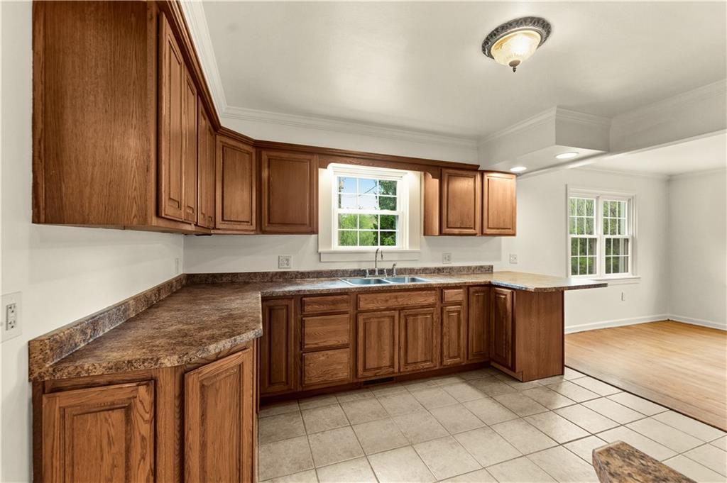 973 Blackhawk Road Beaver Falls, PA 15010 - Photo 9 of 36 a kitchen with granite countertop a sink and a stove