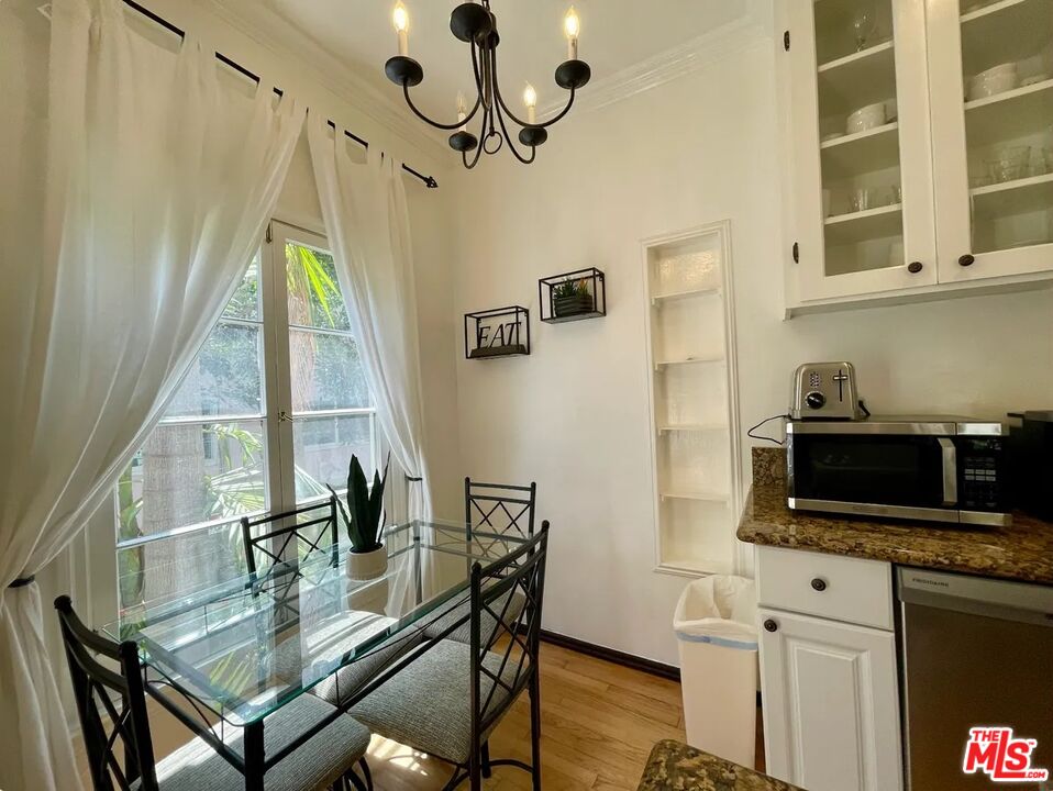 854 4th Street, Unit F Santa Monica, CA 90403 - Photo 2 of 13 a living room with furniture a flat screen tv and a window