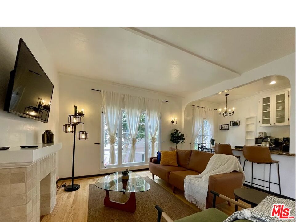 854 4th Street, Unit F Santa Monica, CA 90403 - Photo 3 of 13 a living room with furniture and a flat screen tv