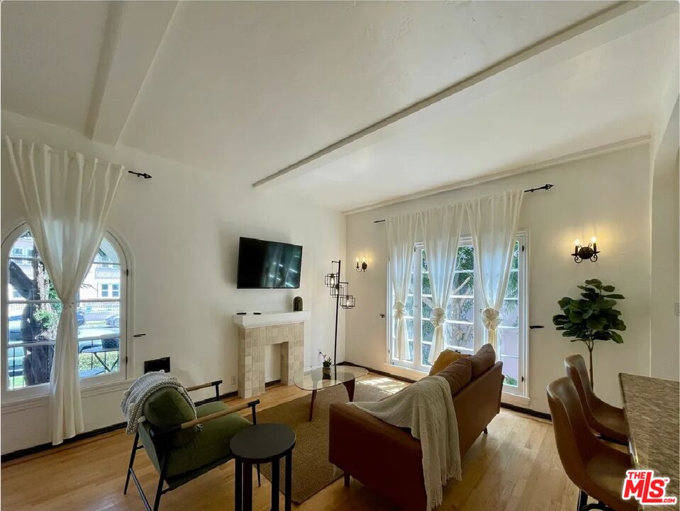 854 4th Street, Unit F Santa Monica, CA 90403 - Photo 5 of 13 a living room with fireplace furniture and a flat screen tv