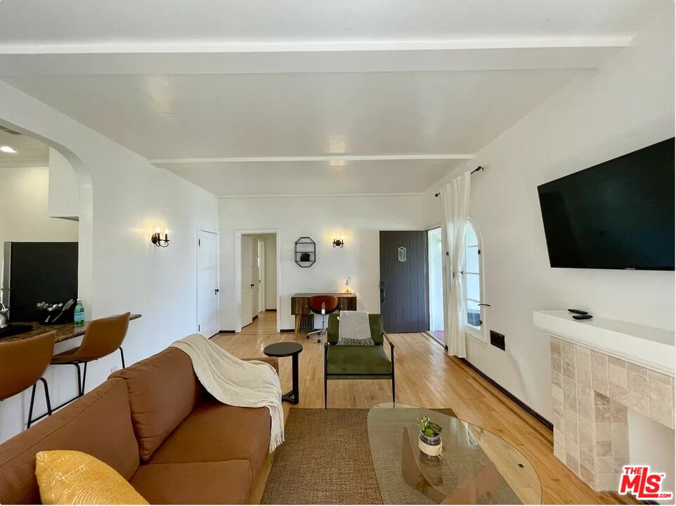 854 4th Street, Unit F Santa Monica, CA 90403 - Photo 6 of 13 a living room with furniture and a flat screen tv