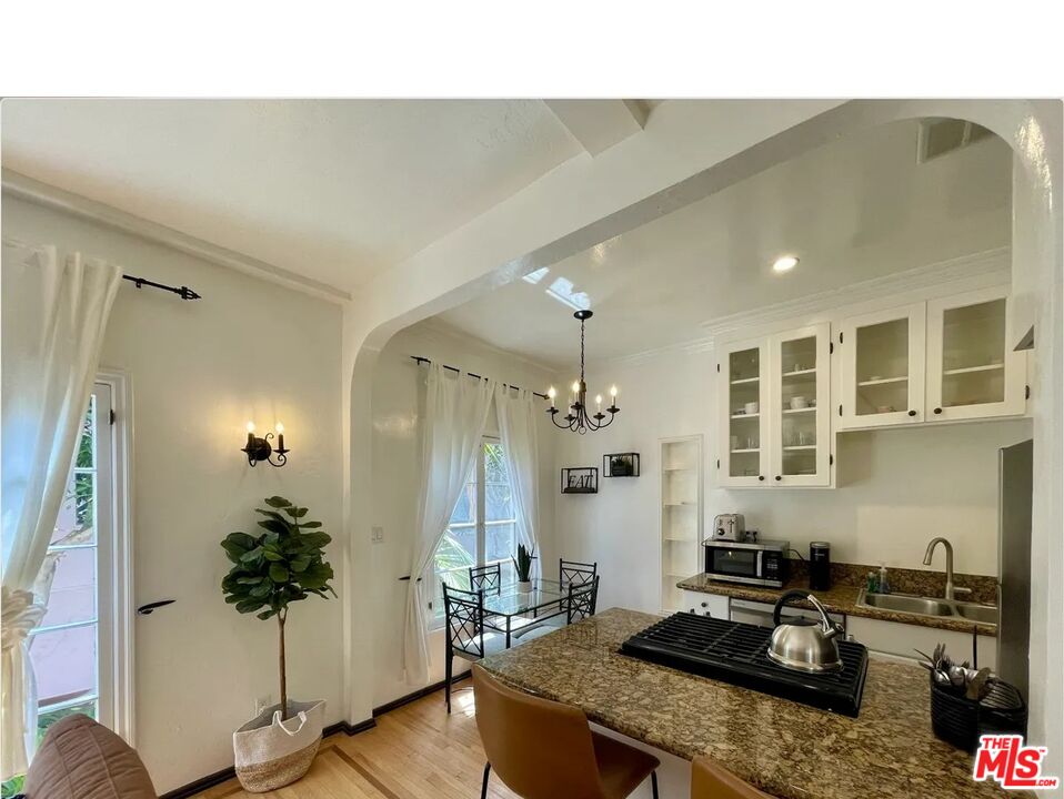 854 4th Street, Unit F Santa Monica, CA 90403 - Photo 8 of 13 a kitchen with a table and chairs in it