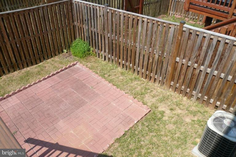 8115 Hard Shale Road Manassas, VA 20111 - Photo 5 of 26 Fenced Backyard with Brick Patio