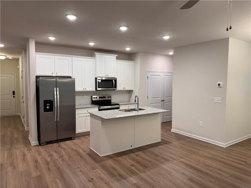 11 Huntley Trace Hoschton, GA 30548 - Photo 2 of 12 a view of kitchen with stainless steel appliances a refrigerator and a stove top oven