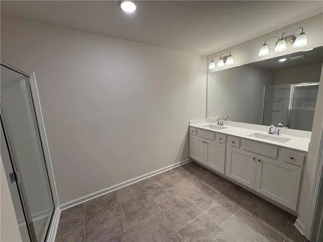 a bathroom with a double vanity sink and mirror