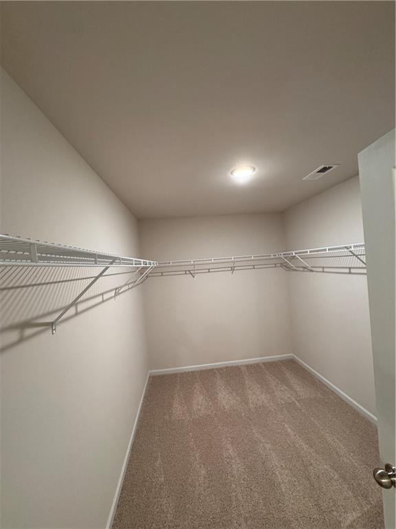 11 Huntley Trace Hoschton, GA 30548 - Photo 8 of 12 a view of a room with racks on the wall