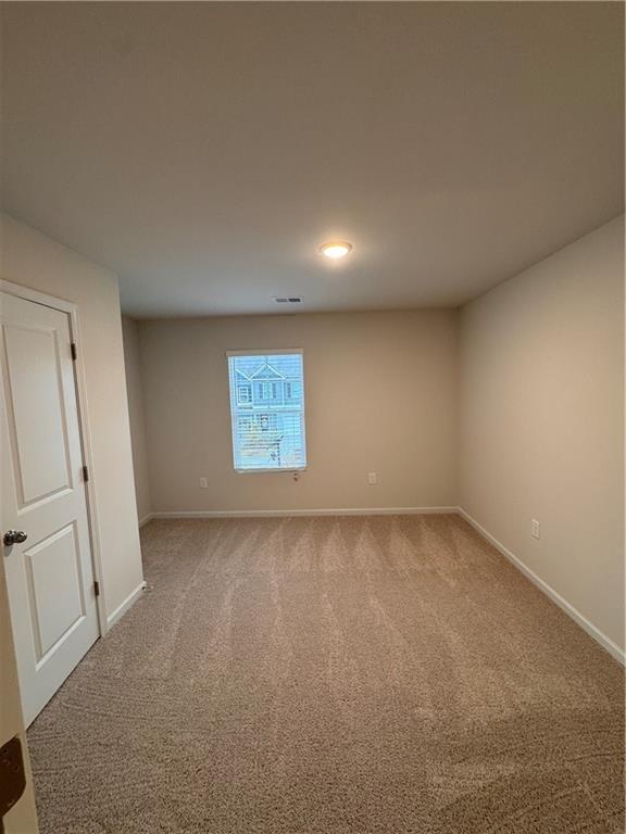 11 Huntley Trace Hoschton, GA 30548 - Photo 9 of 12 an empty room with a window