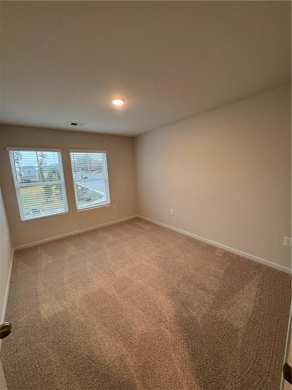 11 Huntley Trace Hoschton, GA 30548 - Photo 10 of 12 an empty room with windows