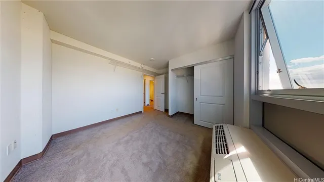 a view of a room with an empty space and a window