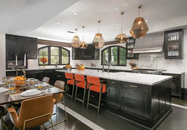 a kitchen with a sink and chairs