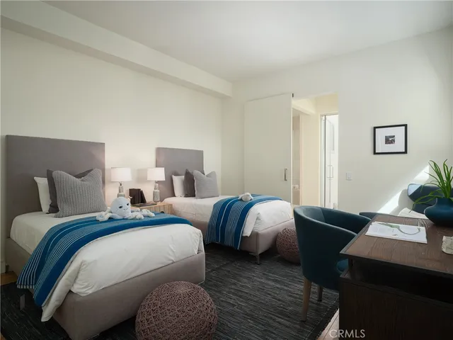 a bed room with two beds and a couch