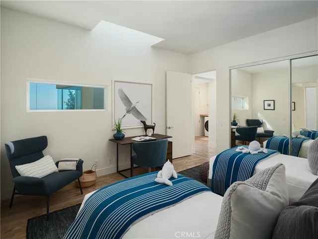 a bedroom with furniture and a wooden floor