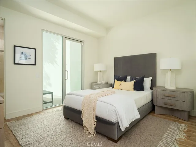 a bedroom with a bed and a night stand