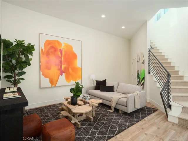 a living room with furniture and a potted plant