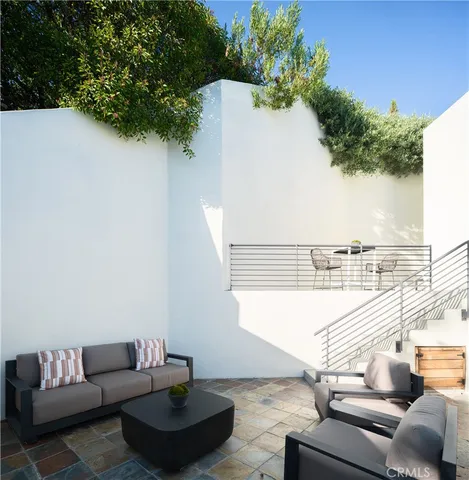 a terrace of a house with outdoor seating