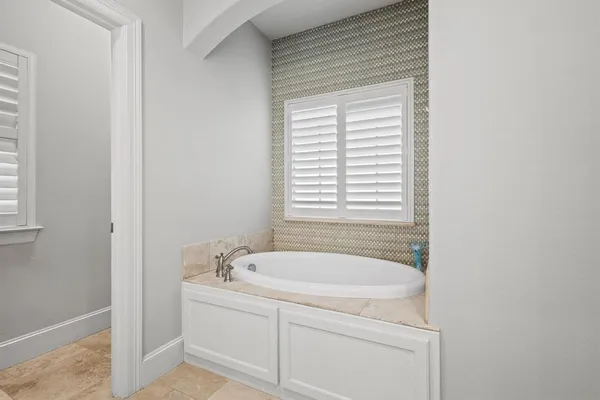 a white bath tub sitting next to a window