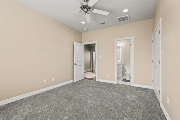 an empty room with fan and entrance