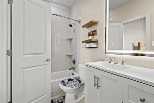 a bathroom with a sink toilet and shower