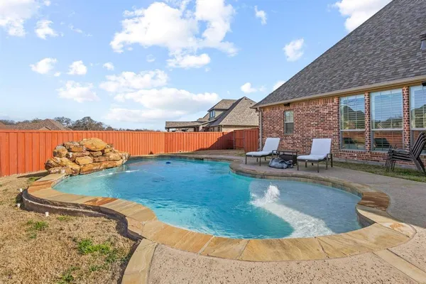 a view of a swimming pool with an outdoor seating