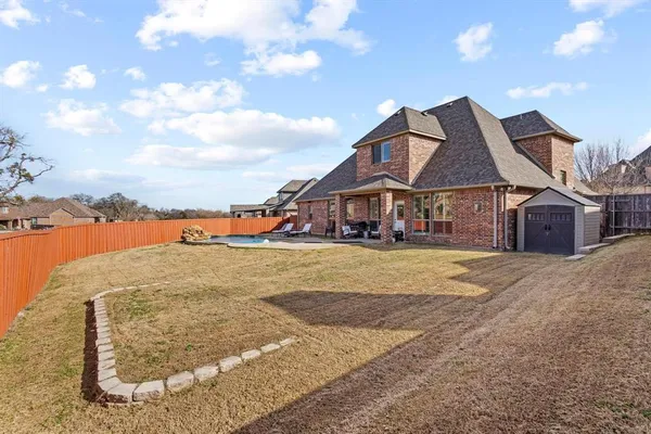 a front view of a house with a yard and lake view