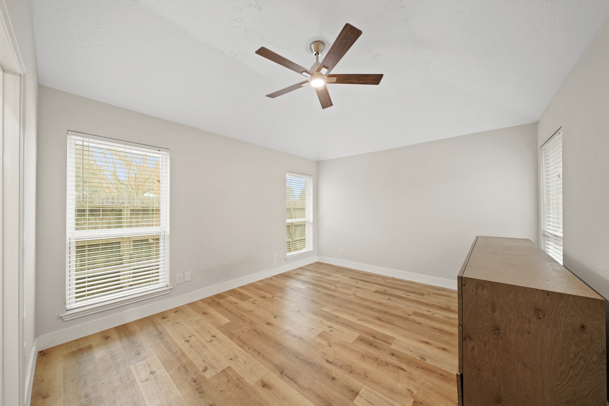 19211 Haystream Drive Katy, TX 77449 - Photo 20 of 31 a view of an empty room with wooden floor and a window