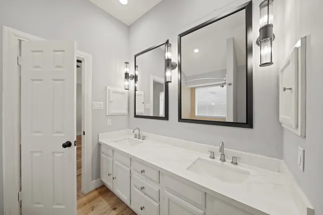 a bathroom with a double vanity sink mirror double and shower