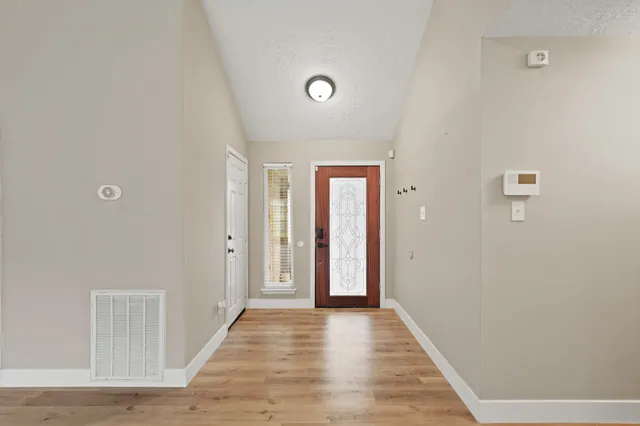 a view of a hallway with wooden floor