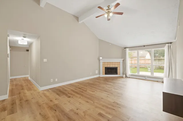 a view of empty room with fireplace and fan