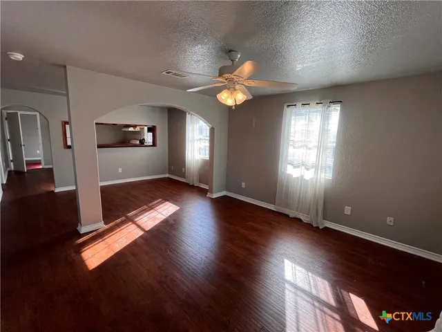 wooden floor in an empty room with a window