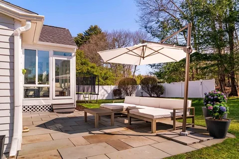 a view of a patio with a table and chairs