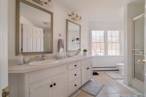 a bathroom with a sink vanity and mirror