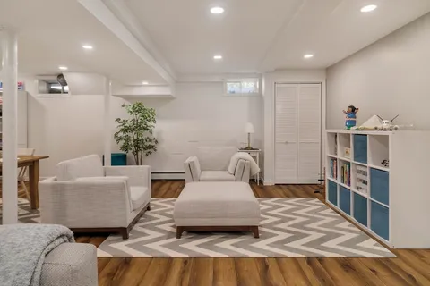 a living room with furniture and a book shelf