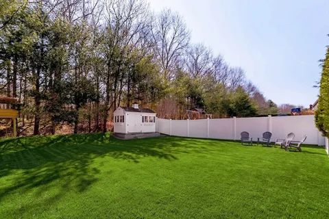 a view of a house with a yard and sitting area