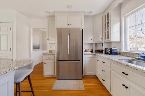 a kitchen with stainless steel appliances granite countertop a refrigerator sink and cabinets