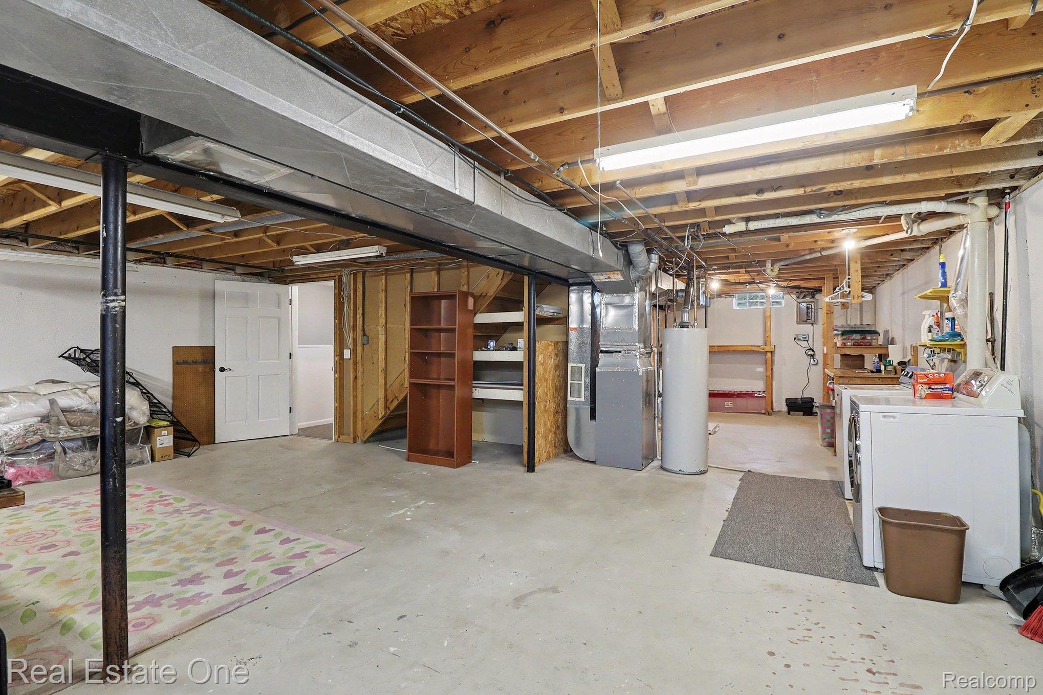 6570 Edgewood Road Canton, MI 48187 - Photo 16 of 22 Unfinished basement featuring exposed wood joists, concrete flooring, and ample space