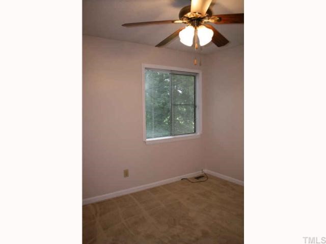 705 Godwin Court Raleigh, NC 27606 - Photo 6 of 11 a view of a room that has a chandelier fan and a window