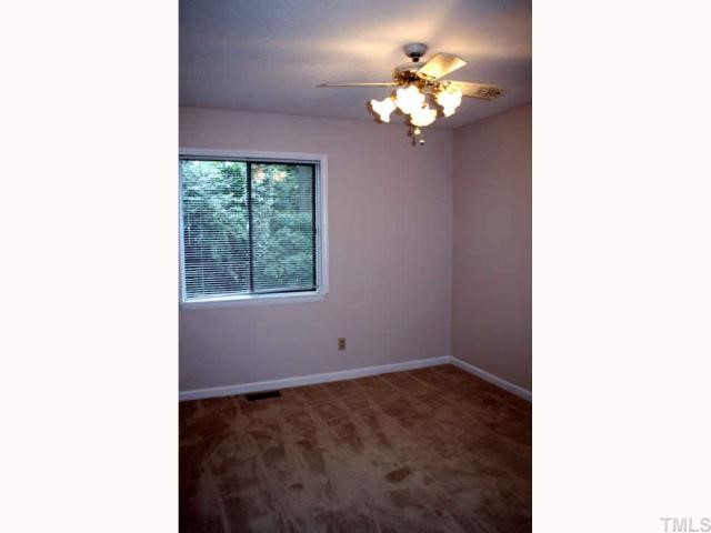 705 Godwin Court Raleigh, NC 27606 - Photo 8 of 11 a picture of a room with a chandelier fan and a window
