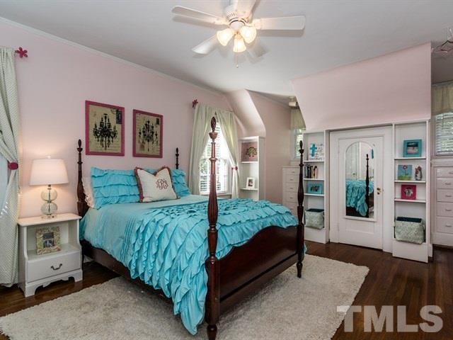 1506 Pineview Street Raleigh, NC 27608 - Photo 19 of 25 a bedroom with a bed and wooden floor