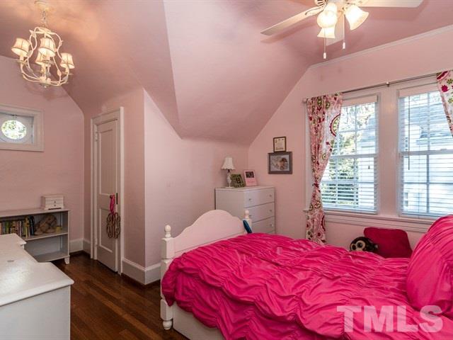 1506 Pineview Street Raleigh, NC 27608 - Photo 20 of 25 a bedroom with a large bed and a window