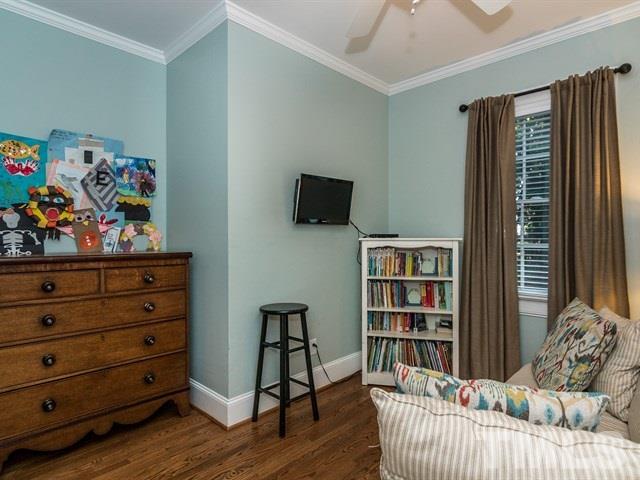 1506 Pineview Street Raleigh, NC 27608 - Photo 21 of 25 a bedroom with furniture and a book shelf