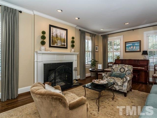 1506 Pineview Street Raleigh, NC 27608 - Photo 4 of 25 a living room with furniture and a fireplace