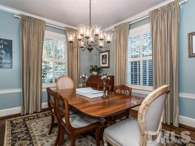 1506 Pineview Street Raleigh, NC 27608 - Photo 6 of 25 a dining room with furniture a chandelier and wooden floor