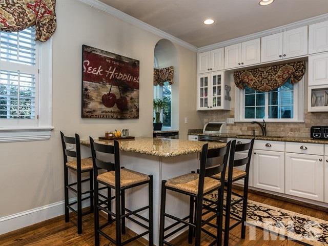 1506 Pineview Street Raleigh, NC 27608 - Photo 7 of 25 a view of a dining room with furniture and wooden floor