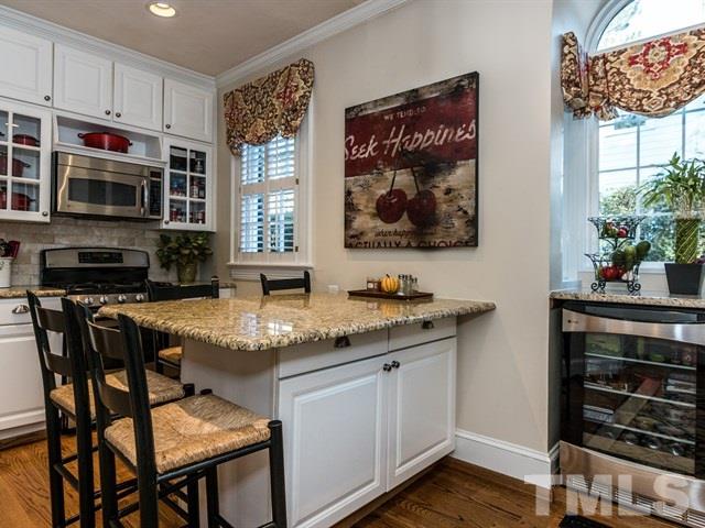 1506 Pineview Street Raleigh, NC 27608 - Photo 8 of 25 a kitchen with stainless steel appliances granite countertop a stove a sink and a microwave