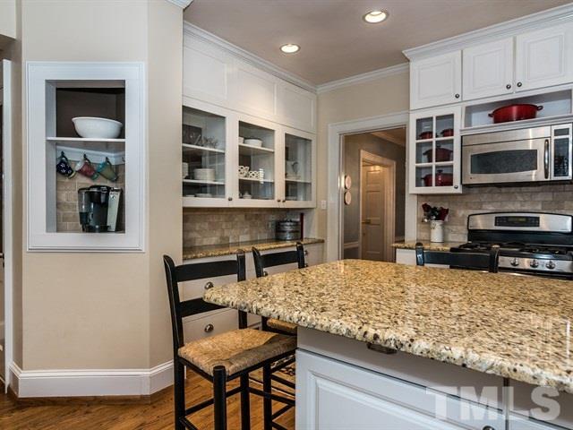 1506 Pineview Street Raleigh, NC 27608 - Photo 9 of 25 a kitchen with stainless steel appliances kitchen island granite countertop a stove and cabinets