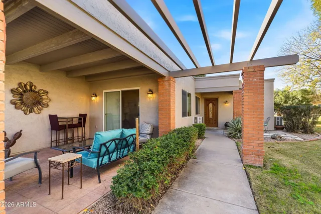 a view of a patio with table and chairs and potted plants