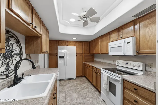 a kitchen with stainless steel appliances granite countertop a sink a stove and a refrigerator