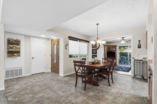 a view of a dining room with furniture and chandelier