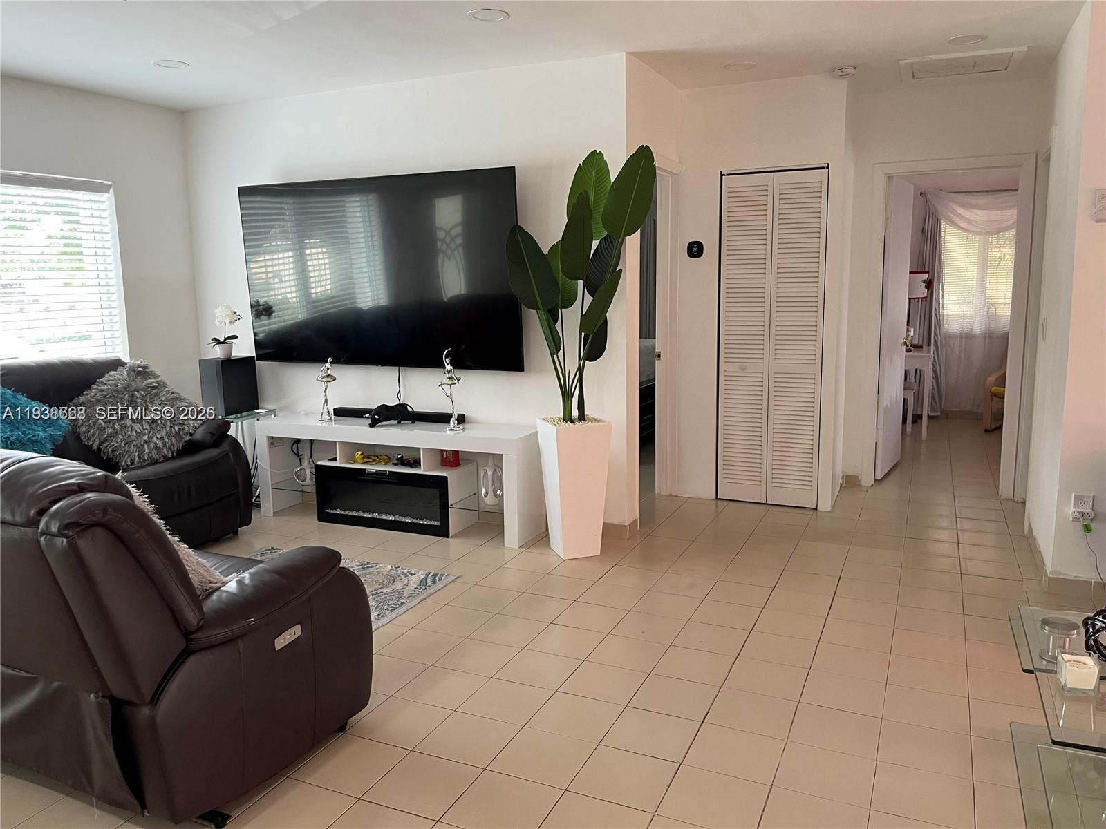 1014 West 68th Street Hialeah, FL 33014 - Photo 12 of 40 a living room with furniture and a flat screen tv