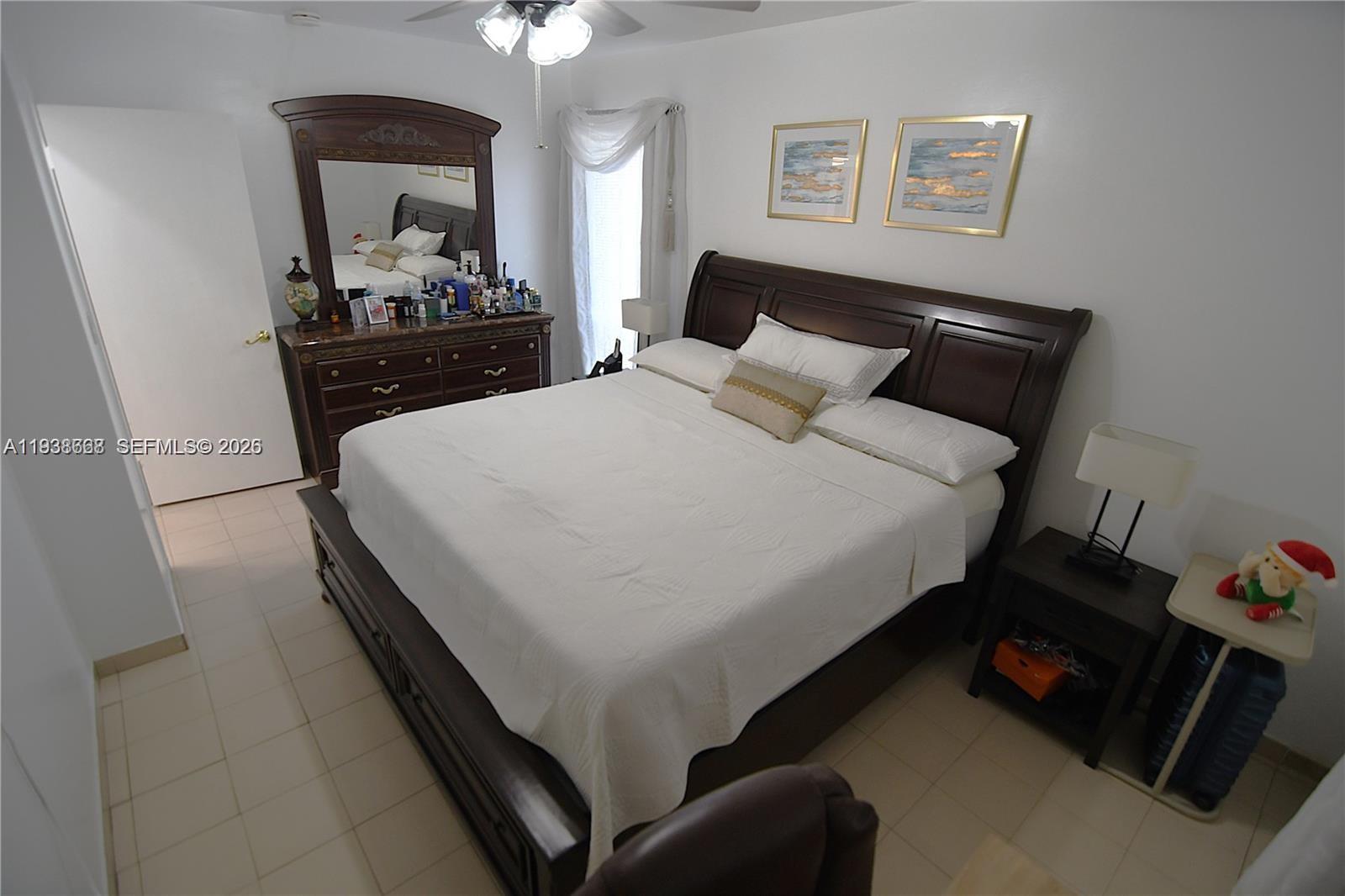 1014 West 68th Street Hialeah, FL 33014 - Photo 14 of 40 a bedroom with a bed and window